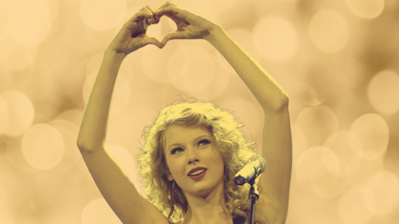 Taylor Swift doing heart hands in the fearless era